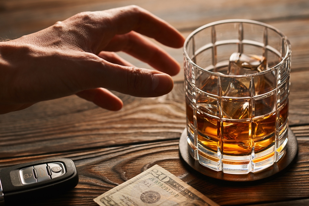 image of man reaching for a glass